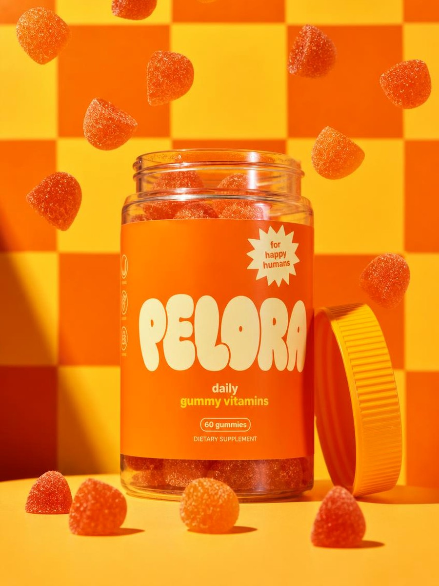 PELORA daily gummy vitamins jar with orange gummies on an orange checkerboard set, in house packaging concept produced by PELORA Marketing