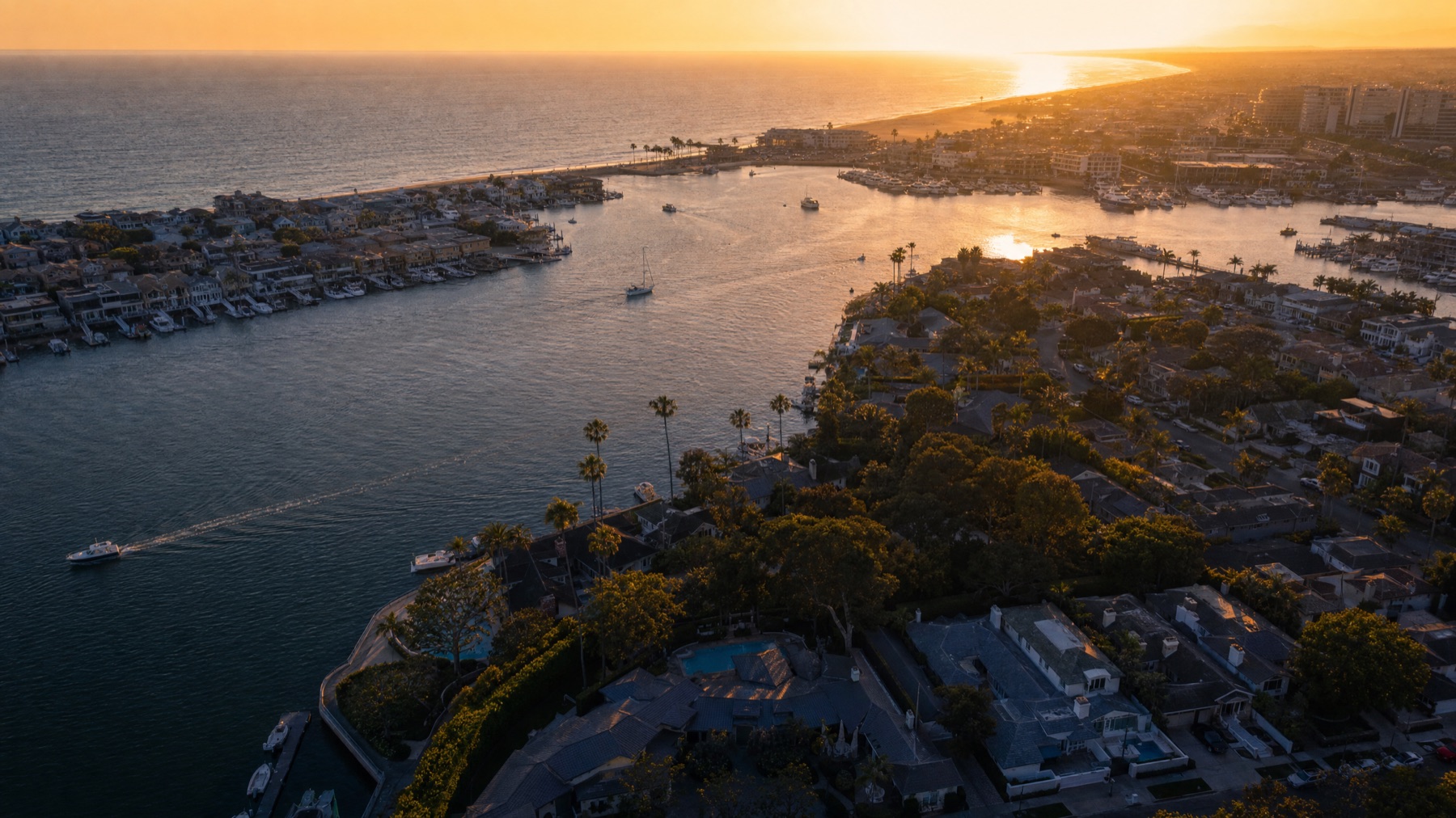 Golden hour aerial view of the Newport Beach coastline and harbor in Orange County, California