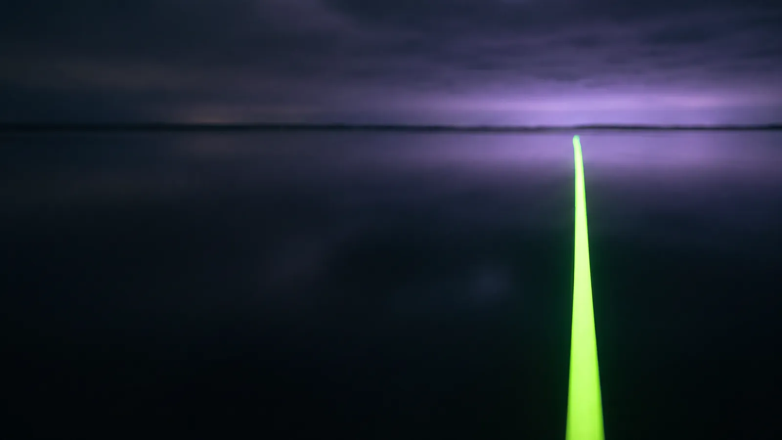 Concept render: a path of green light across dark water