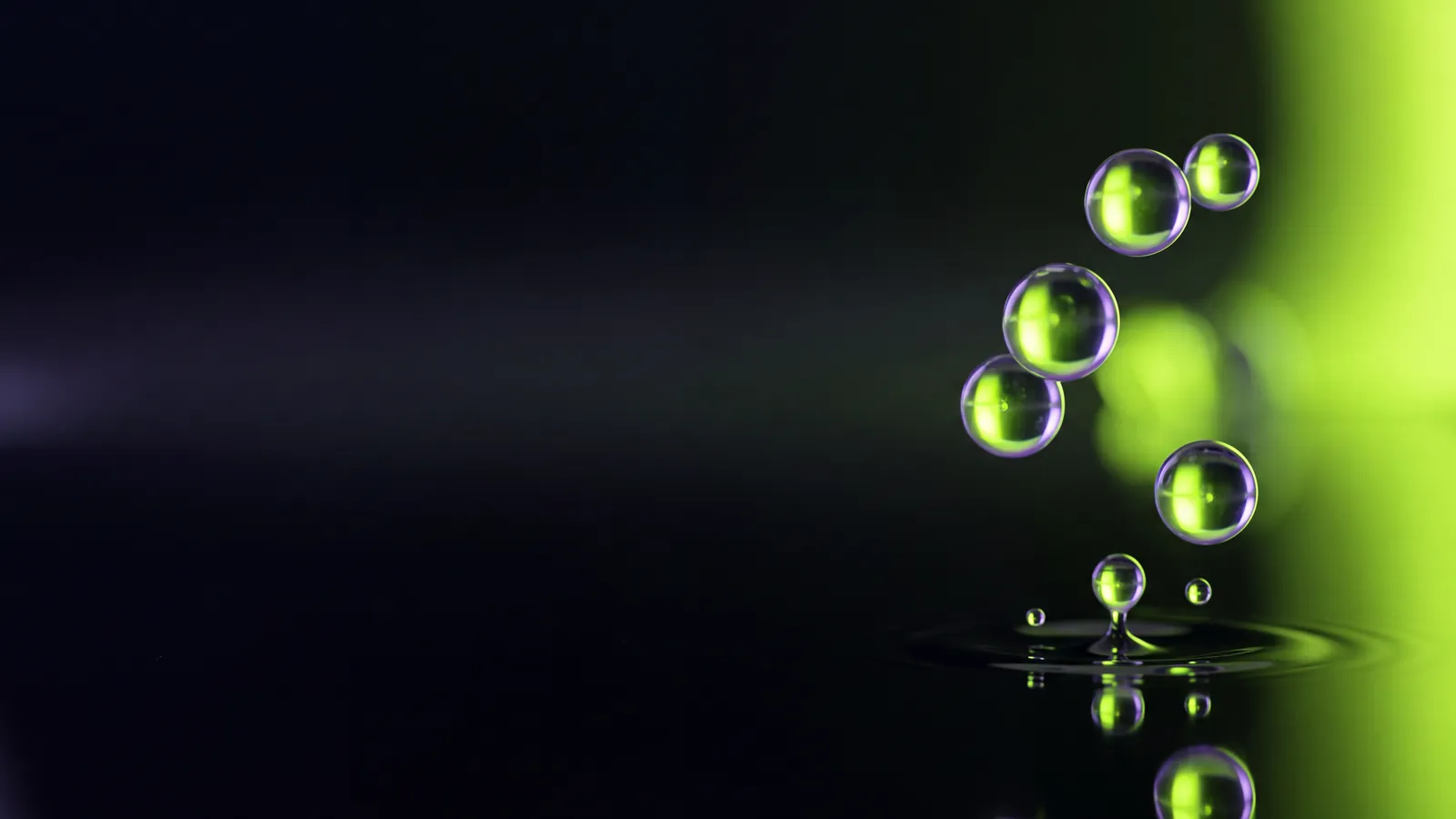 Concept render: serum droplets in green light above black glass