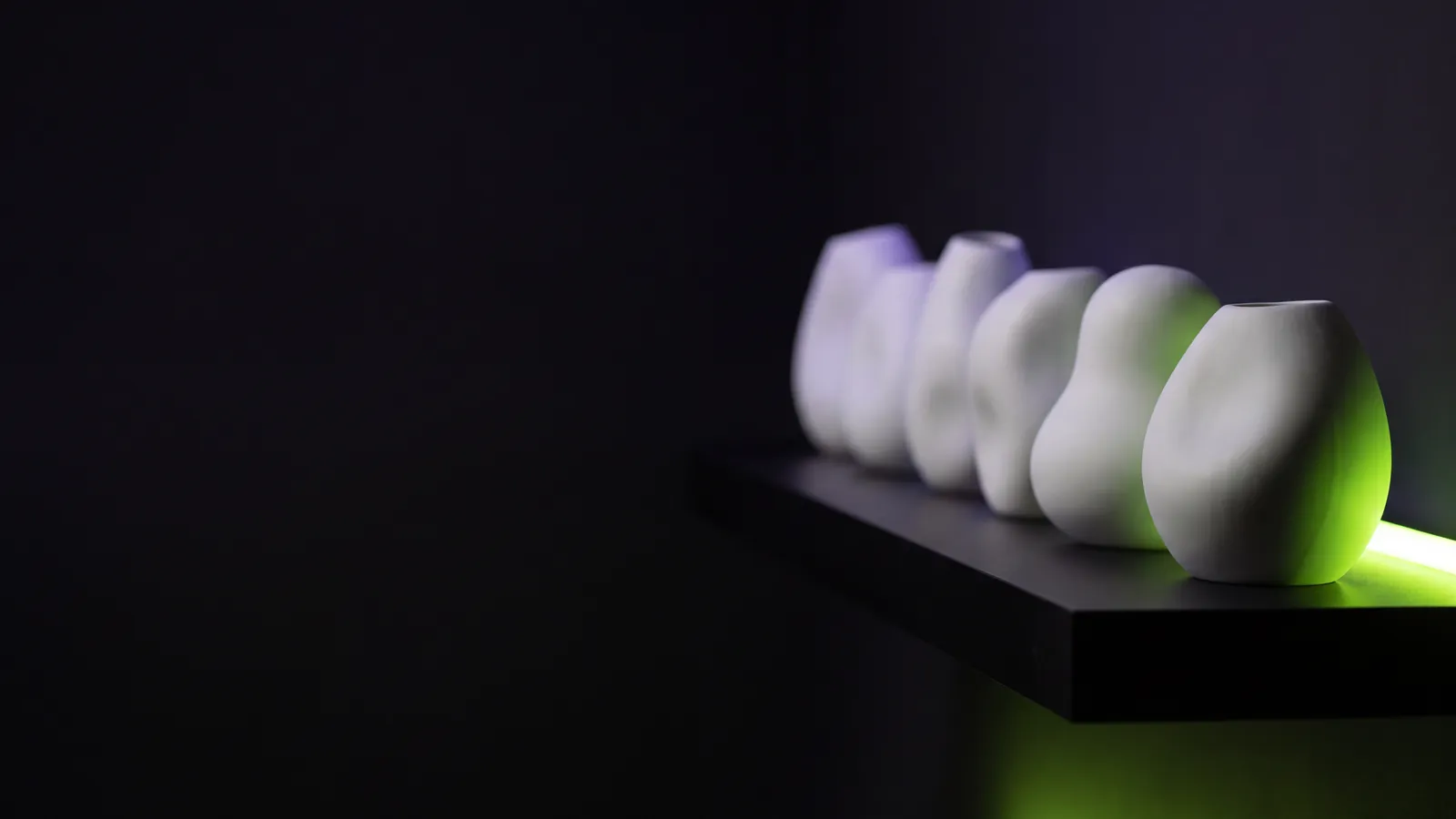Concept render: a row of white ceramic shapes, the nearest lit green
